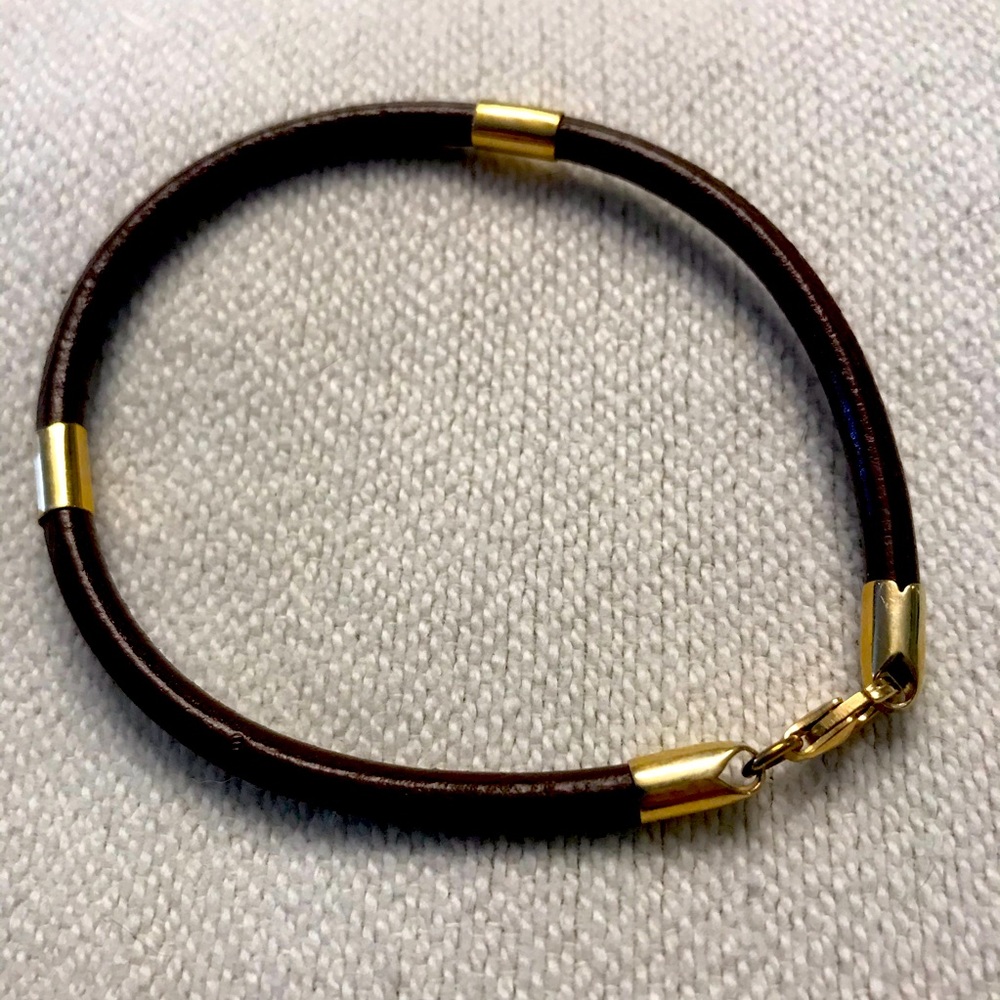Leather bracelet with gold clasp and accents